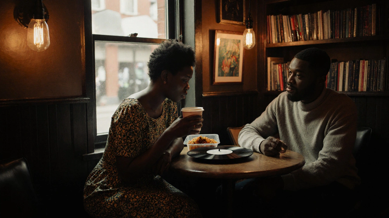 A woman and man having quiet conversation in Deptford Lounge, with vinyl records and cultural food on the table.