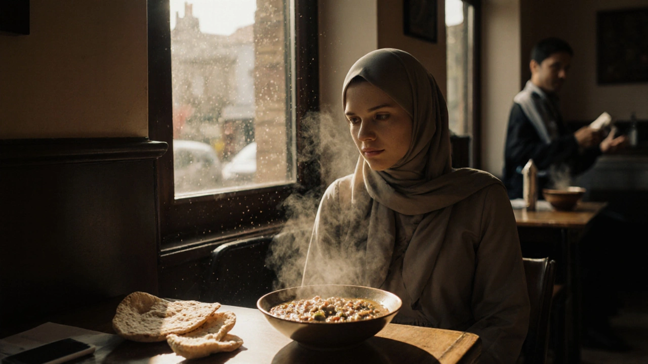 A woman eating lunch alone at a small Isleworth café, steam rising from soup, peaceful and unobtrusive.