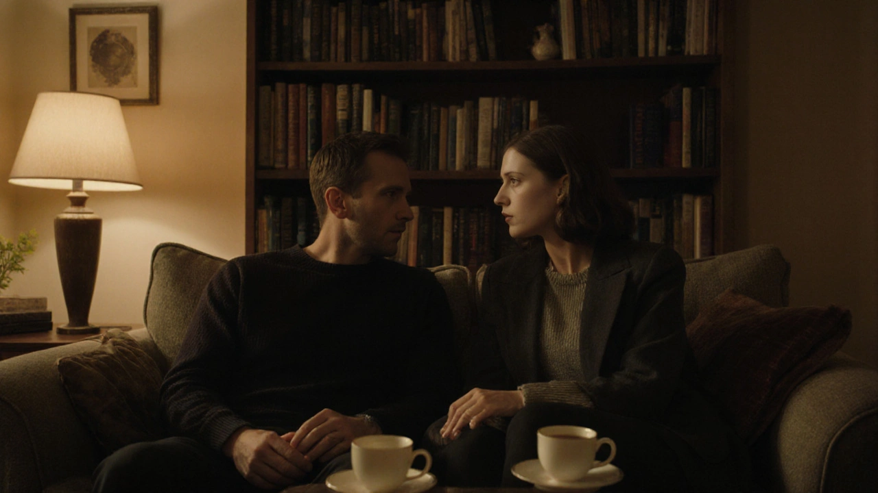 Two people sit calmly on a sofa in a cozy flat, talking over tea with quiet connection.