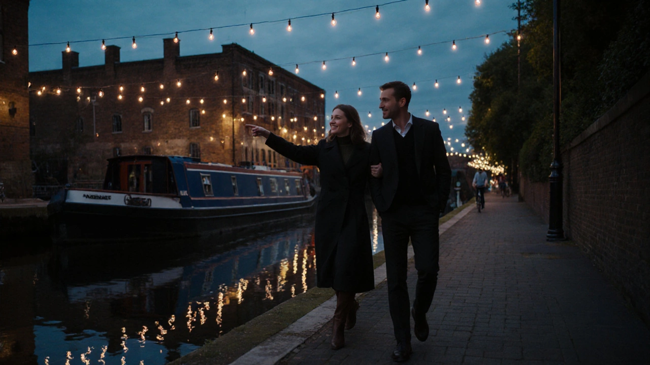 Two people walking peacefully along the Regent’s Canal at dusk, reflections in the water, city lights glowing softly behind them.