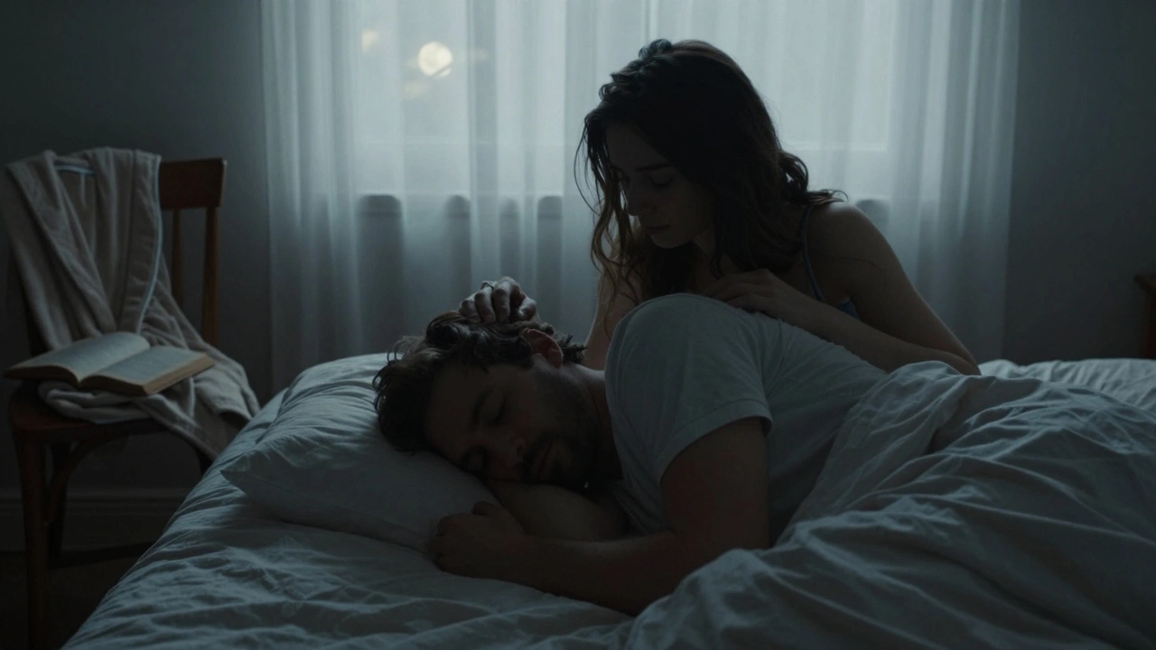A man rests his head on a woman&#039;s shoulder in a softly lit bedroom, she gently strokes his hair in a moment of quiet care.