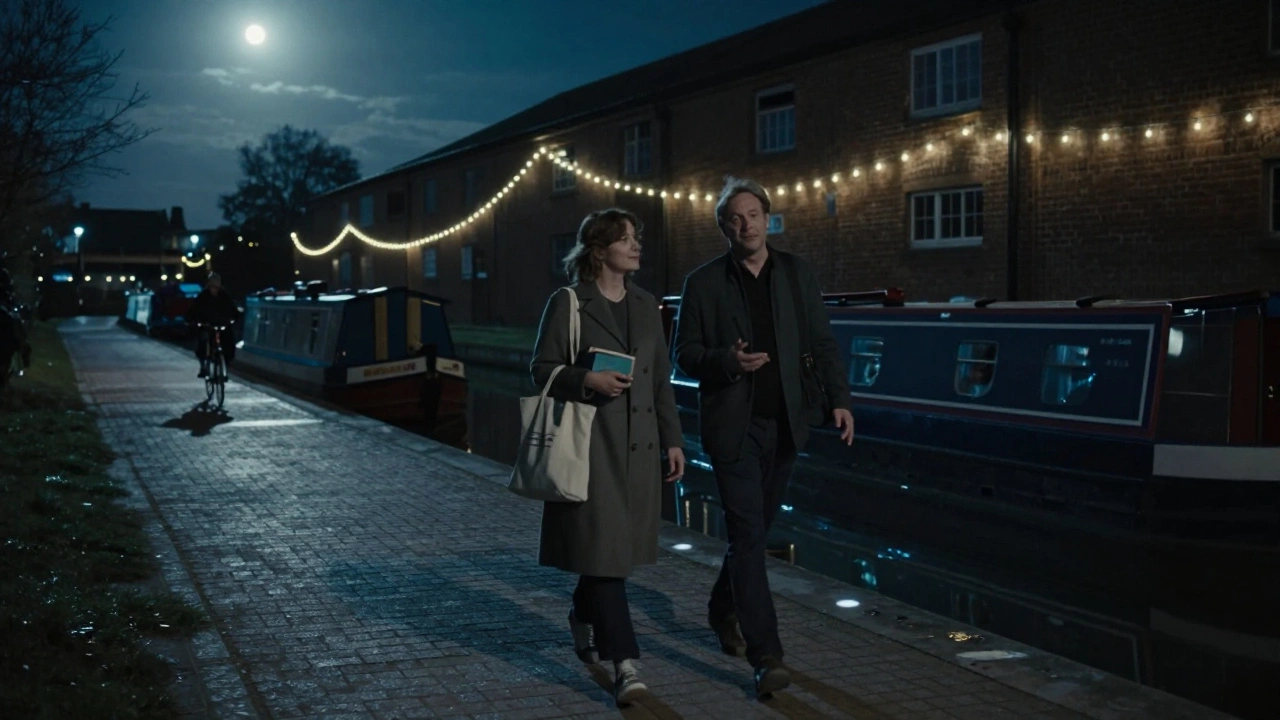Two people walking along the canal at dusk in Stratford, shadows stretching on the water.