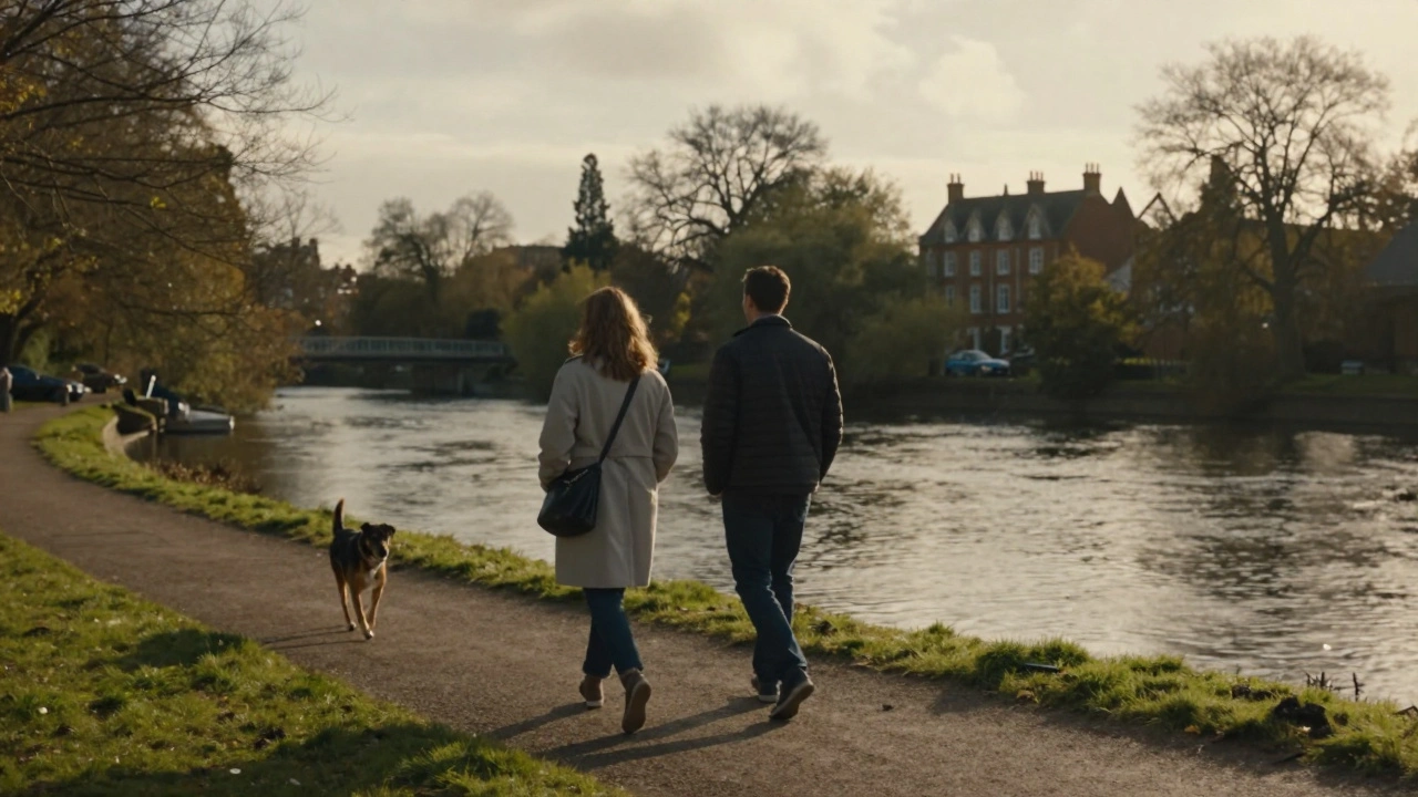 A couple walking peacefully along the River Brent at golden hour.