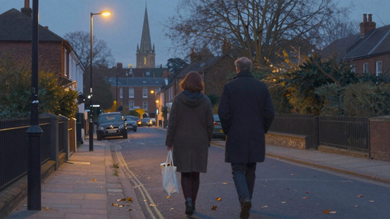 Two individuals walk peacefully down a residential street at dusk under soft streetlights.