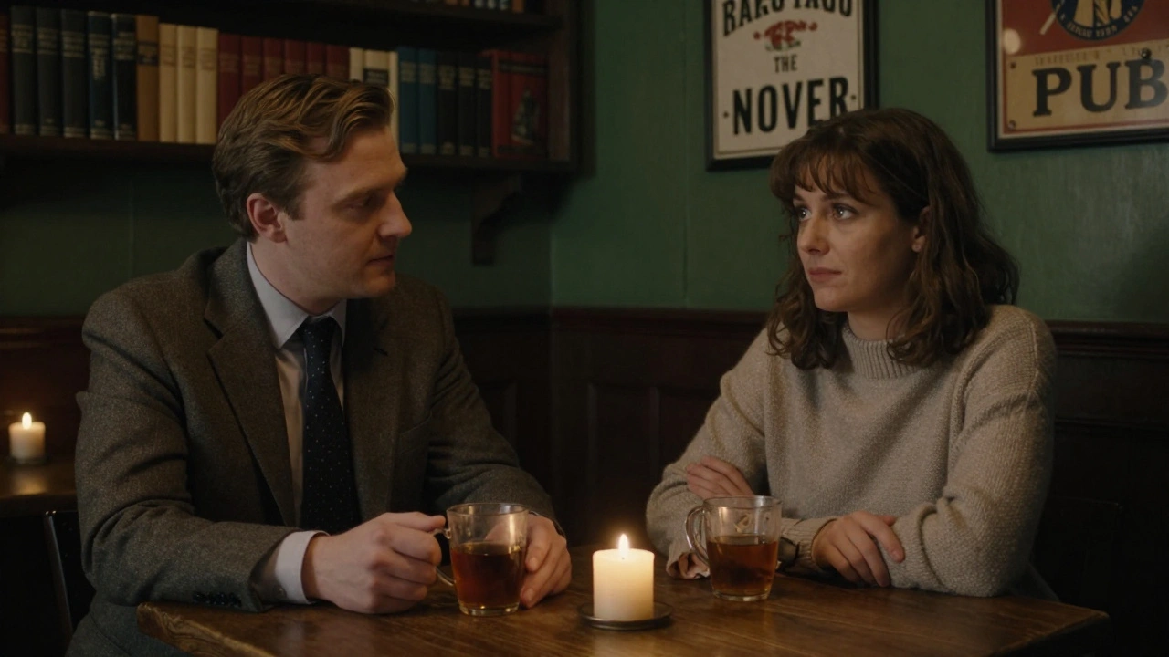Two people sit quietly in a pub lounge with tea, sharing a calm, respectful moment in soft candlelight.