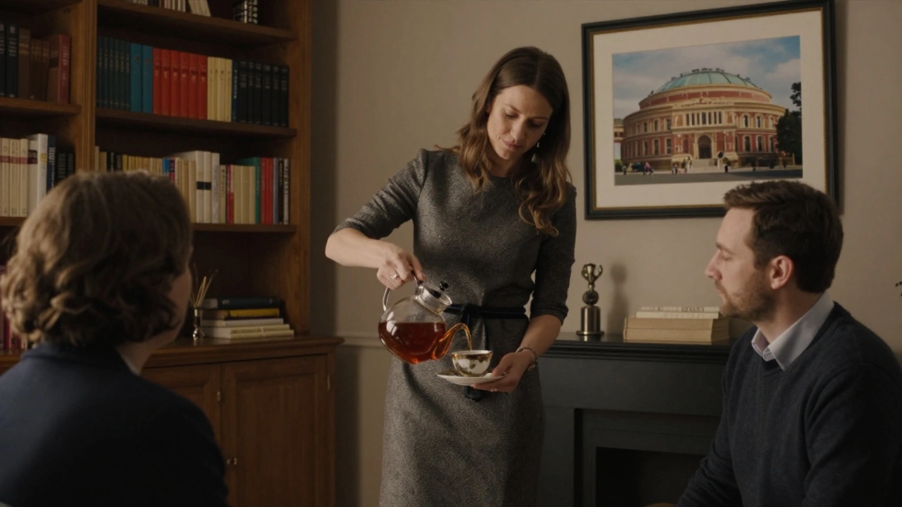 A woman in a tailored dress serves tea in a quiet, book-filled apartment with warm ambient lighting.
